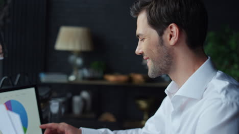 Businessman-looking-at-graphs-on-laptop-screen-at-office.-Manager-using-laptop