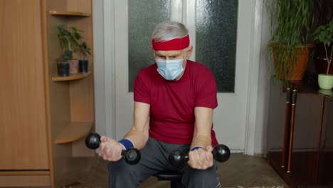 senior man working out at home with weights