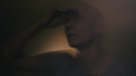 a bald man looks through the glass in the operation room