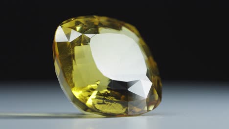 Polished-yellow-gemstone-rotates-and-sparkles