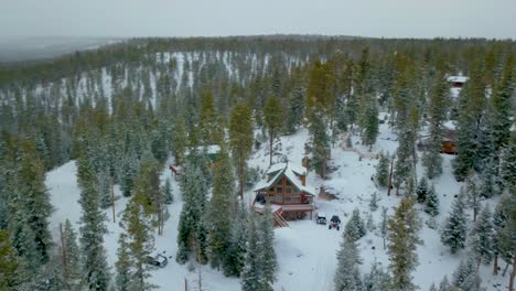 Aerial-View-of-Snow-Covered-High-Mountain-Cabins-during-Winter-Storm