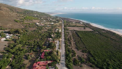 Ultra-wide-aerial-view-of-the-E-5-roadway-going-down-Spain's-coastline