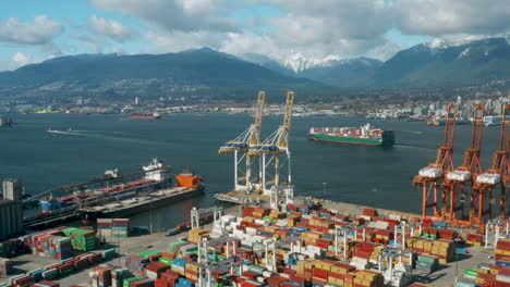 Aerial-view-over-Vancouver-Harbour-as-a-large-container-ship-leaves-port