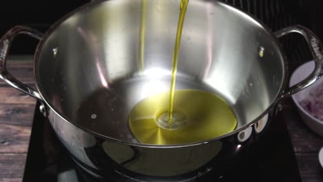 adding oil to hot pan in slow motion