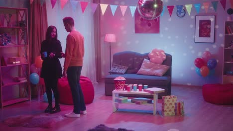 couple dancing at a neon-lit party