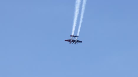 bi-planes execute coordinated stunts in clear skies