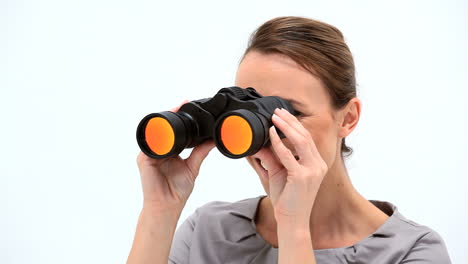 smiling businesswoman looking through binoculars