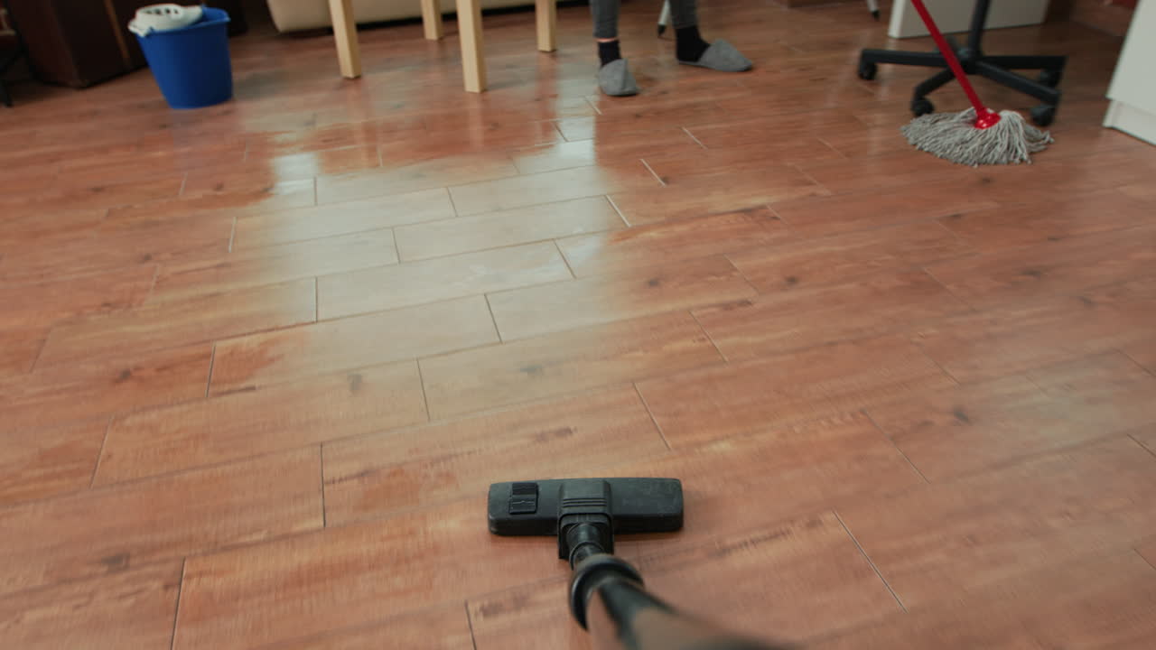 POV of person using vacuum cleaner to tidy up apartment