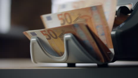 closeup counter calculating euro bills. machine counting european currency.