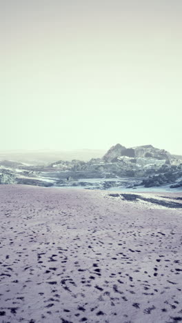 a vast desert landscape with footprints in the sand.