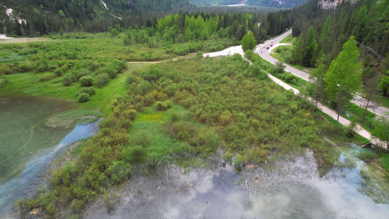 Lake Landro's white waters reflect the sky in green valley