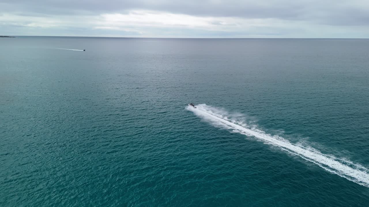 Jet Ski flying across the water as drone chases behind