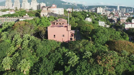 Fort-Santo-Domingo-on-sunny-day-surrounded-by-green-trees---New-Taipei-City,-Taiwan