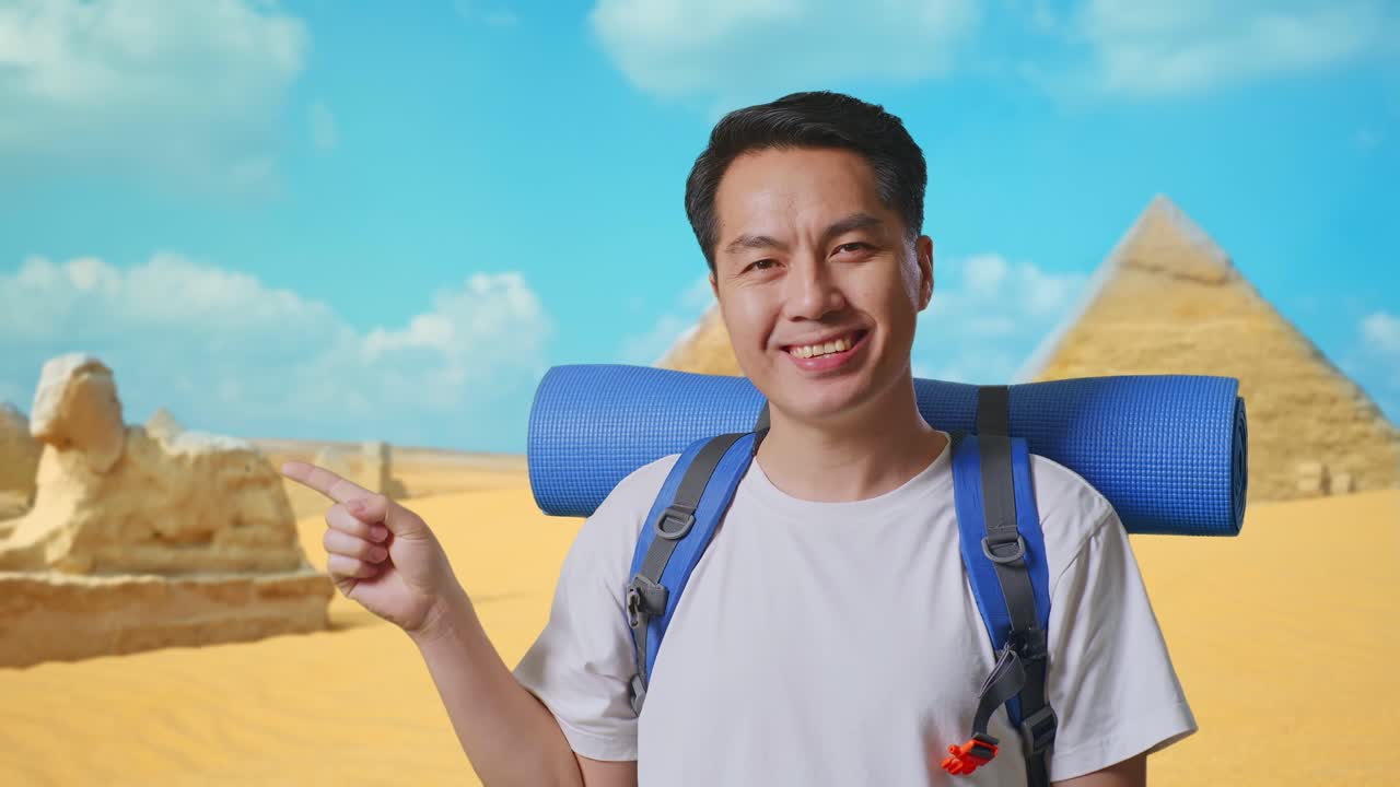 Close Up Of Asian Male Hiker With Mountaineering Backpack Smiling And Pointing To Side While Traveling In Pyramid Of Giza