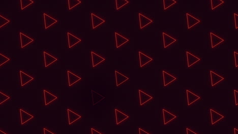 red neon triangles in rows on black gradient