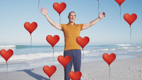animación de globos de amor de corazón rojo iconos digitales sobre el hombre mayor sonriente en la playa