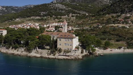 coastal town with church and beach in croatia