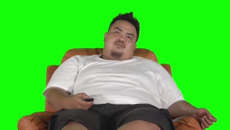 overweight man relaxing on sofa while watching tv