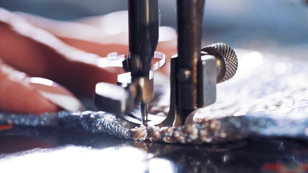 Hand on old sewing machine. Seamstress making new clothing concept
