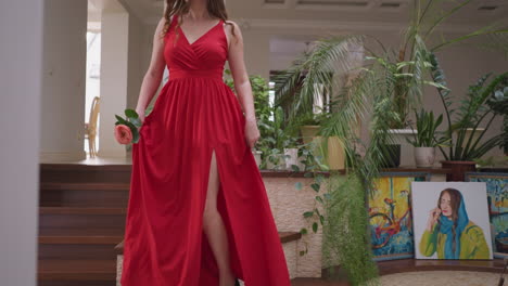 woman in a red dress sitting on a staircase