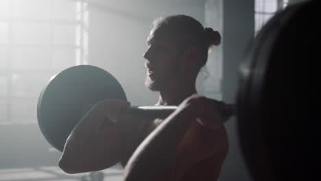 man lifting weights during workout. bodybuilder doing exercises with barbell