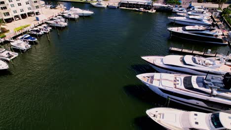 Slow-aerial-shot-of-boats-in-the-blue-water-blue-sky-palm-trees-ft