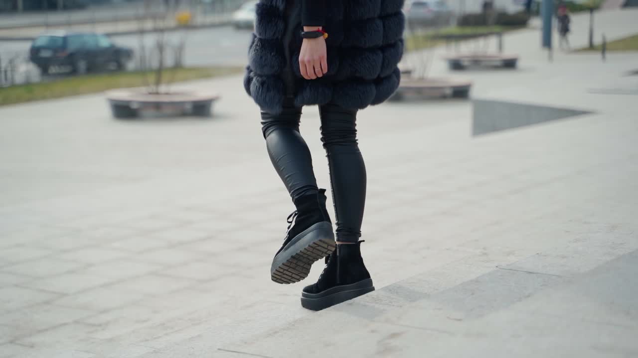 Woman posing on street in city. Close up of beautiful young woman posing against city background