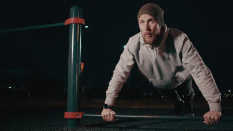 man doing push-ups at night