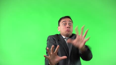 businessman reacting with intense fear and distress on green screen