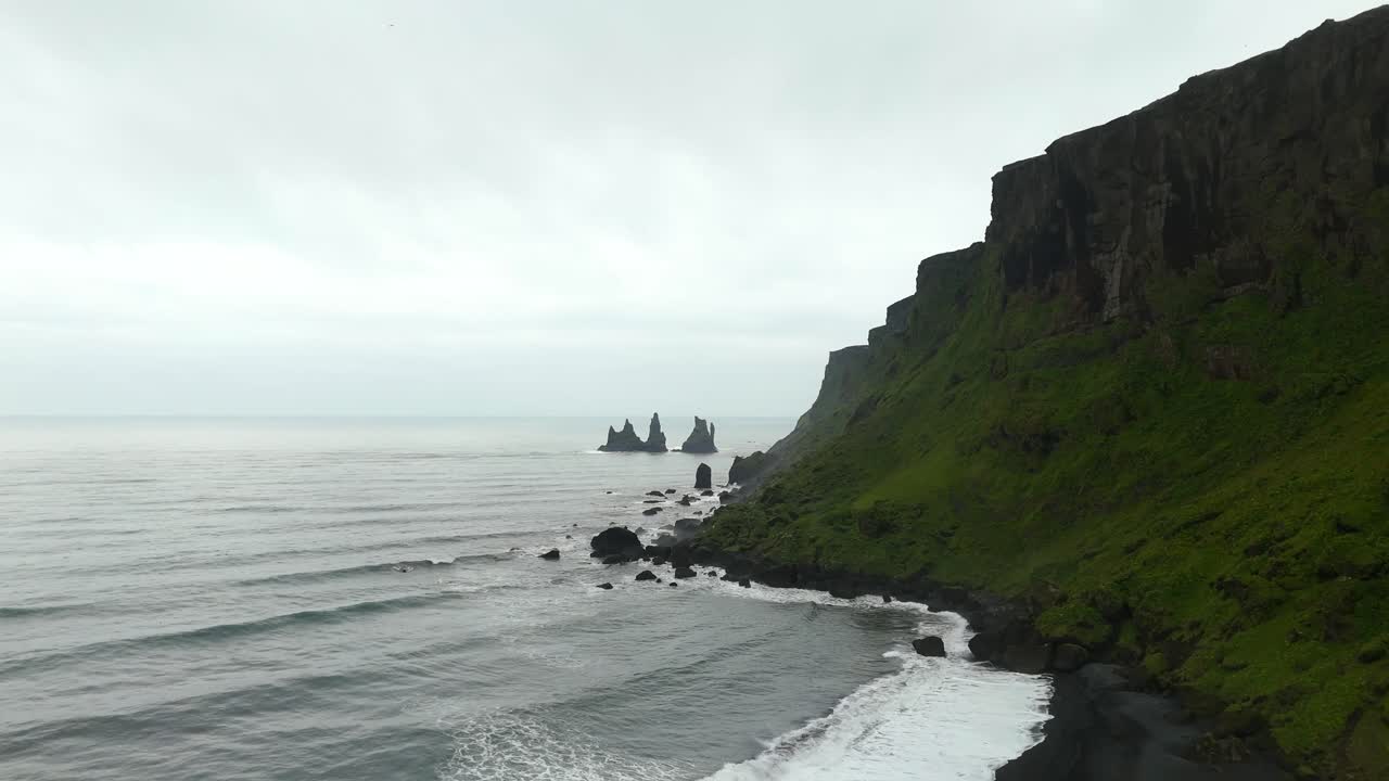 Watch as the drone showcases Vik’s iconic Reynisfjara beach, with its dramatic basalt columns and crashing waves, creating a mesmerizing dance of land and sea.