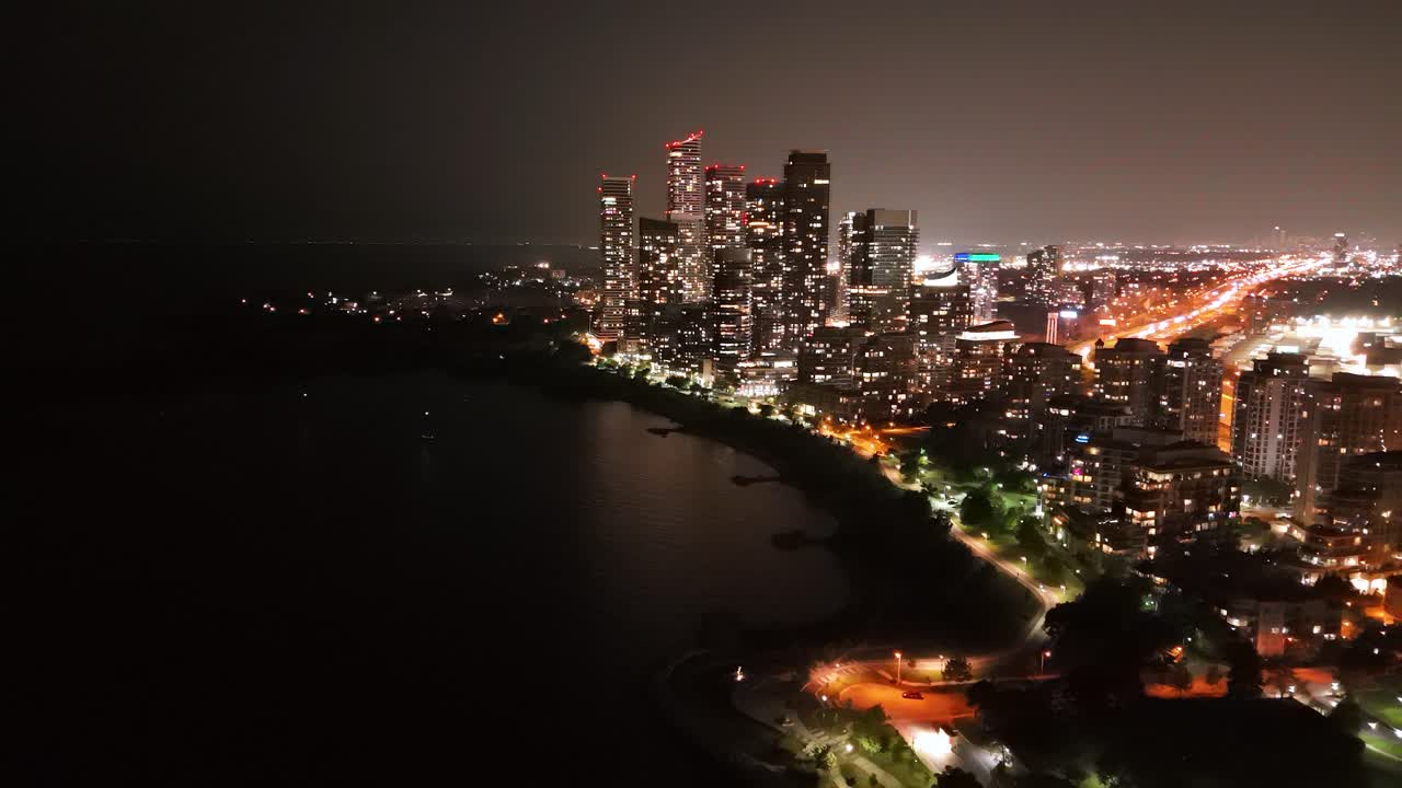 Parklawn neighbourhood skyline at night, featuring lights and a calm waterfront view