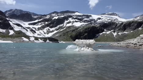 pack of floating ice and snow in a beautiful blue lake in the austrian alps, uttendorf weissee