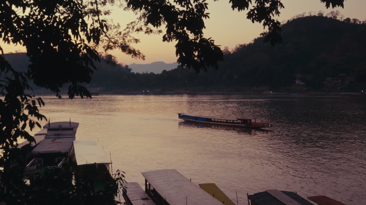 Sunset over the Mekong River with riverboats