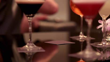 people savoring drinks at a stylish bar