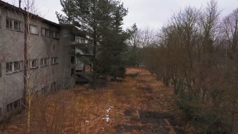 aerial shot during snow near abandoned barracks at an deserted military base in poland