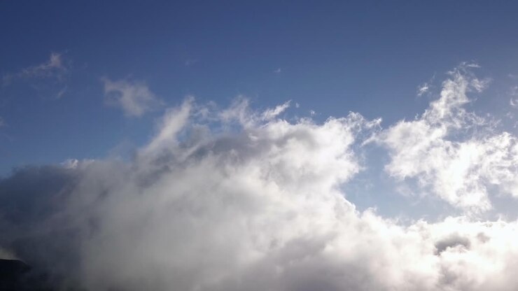 Stunning Aerial View of Fluffy White Clouds Against a Deep Blue Sky
