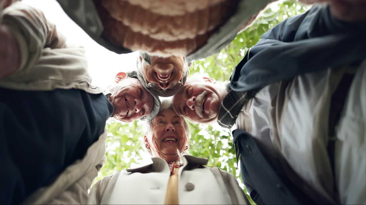 Group of senior friends looking down at the camera