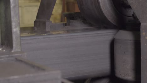 steel beam processing in industrial setting