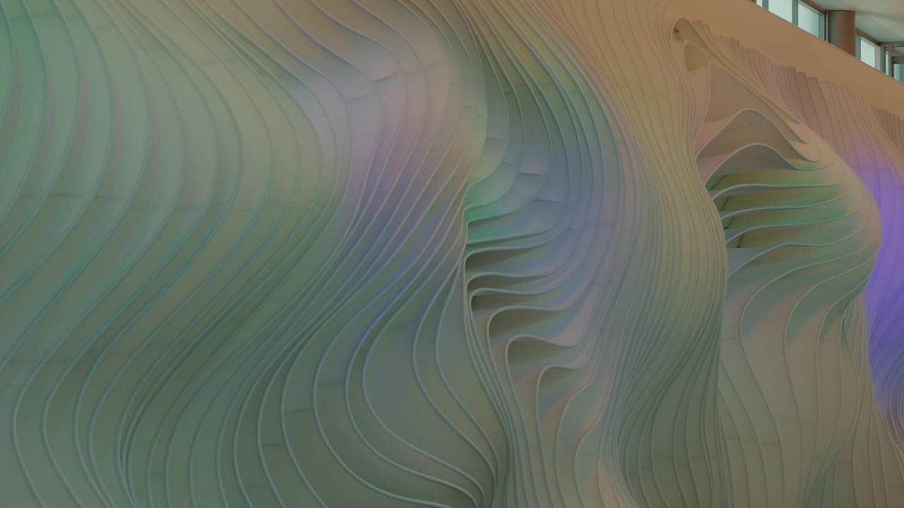 Camera glides left to right across layered curved wall panels in soft pastel light.