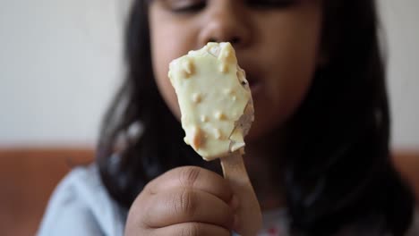 a child eating a white chocolate hazelnut ice cream bar