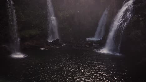 shot of a secret location of four freshwater waterfalls all gushing into the same pool