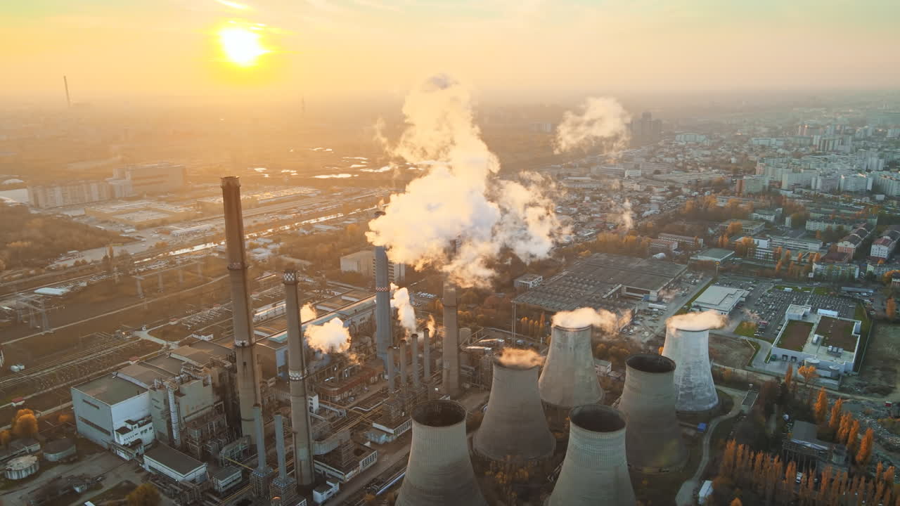 Power station with a lot of tubes and facilities in Bucharest at sunset, a lot of foam. Cityscape, view from the drone, Romania