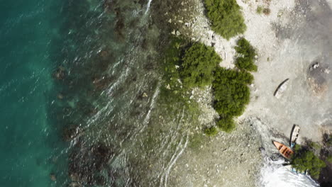 aerial - coastline of monte rio, azua, dominican republic, top down descending