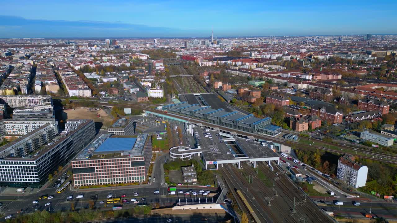 Berlin cityscape with a modern train station South Cross and extensive railway lines under a clear sky. Amazing aerial view flight wide orbit overview drone
