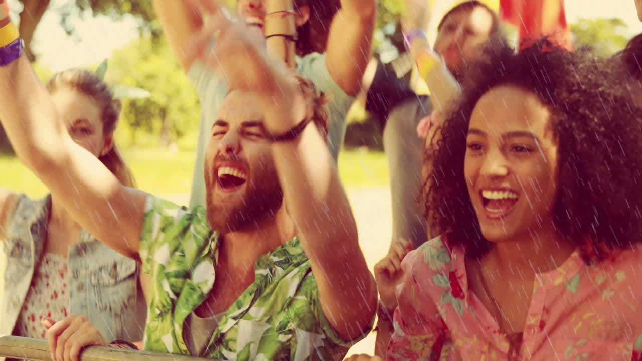 Celebrating outdoors, joyful people raising arms, smiling, enjoying moment together