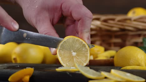 men hands cut juicy lemon on the cutting board.