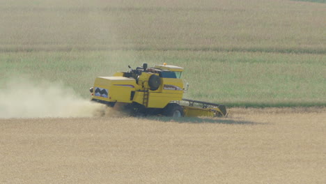 wide shot of a seeder tractor harvesting soybeans in the country