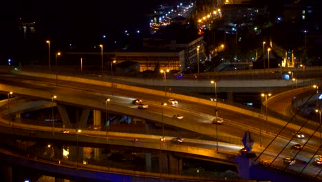 cars driving on roads and highways in bangkok city at night in transportation concept, thailand