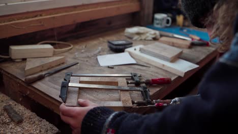 man building wood frame - tools and woods on the table - close up