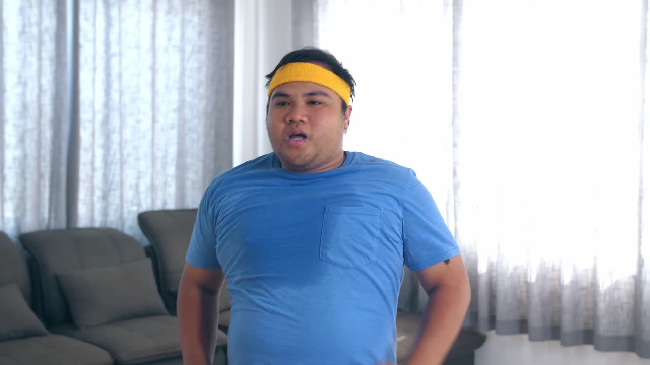 Overweight Man Jogging In Place At Home, Losing Weight